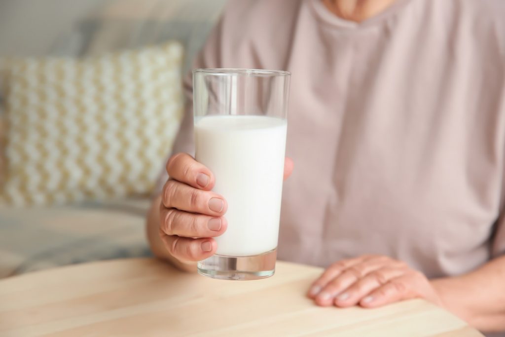 holding a glass of milk