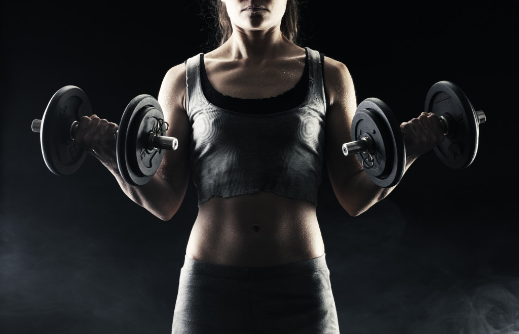 woman lifting weights in the dark