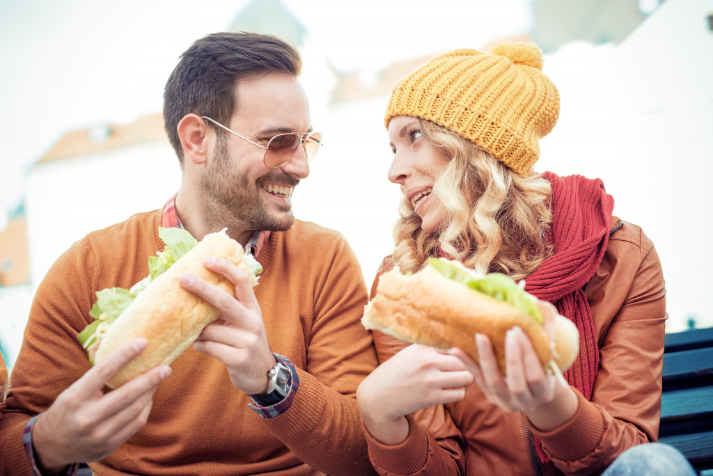 couple eating sandwich together