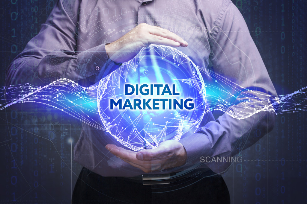 A man holding a sphere with digital marketing