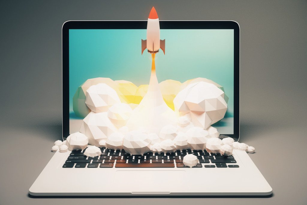 A spacecraft launching on top of laptop