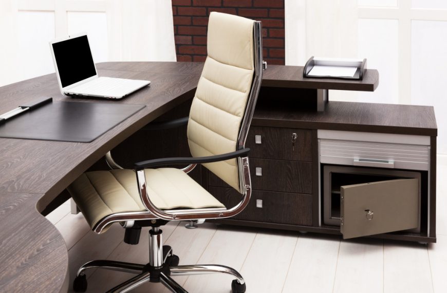 An image of an office desk and chair set with cabinets