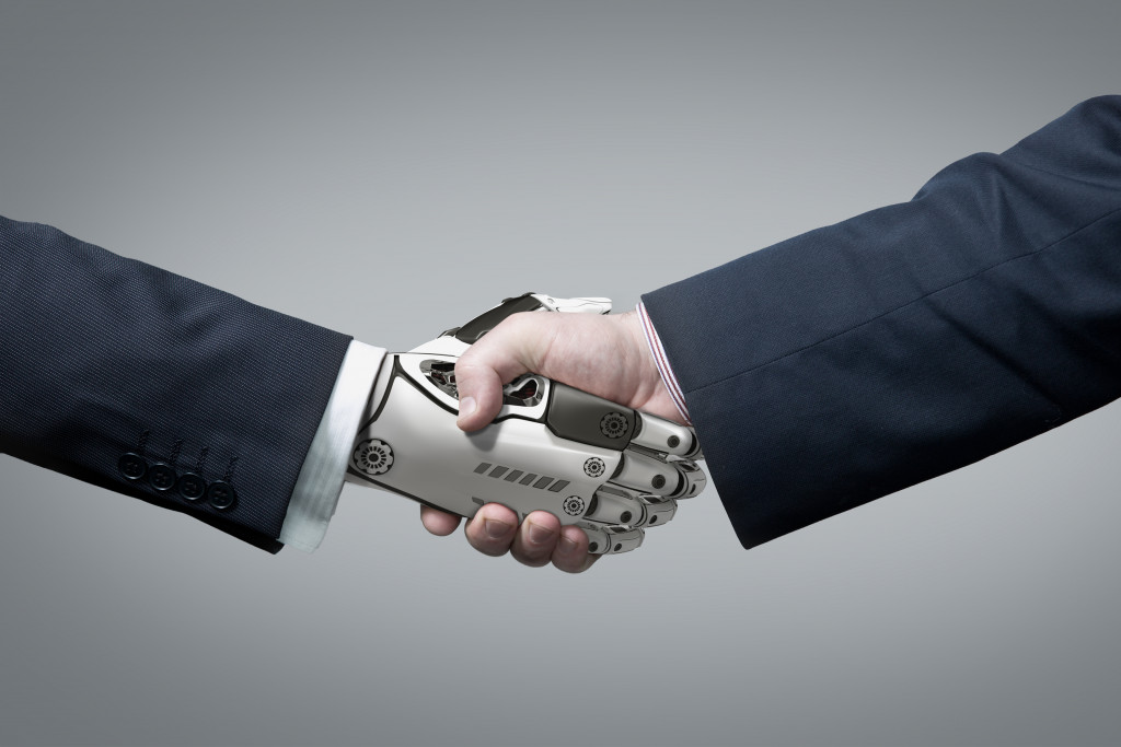 A robot hand and human hand shaking