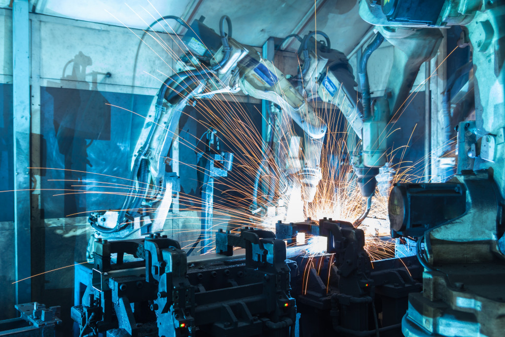 automated robots welding an equipment in a factory